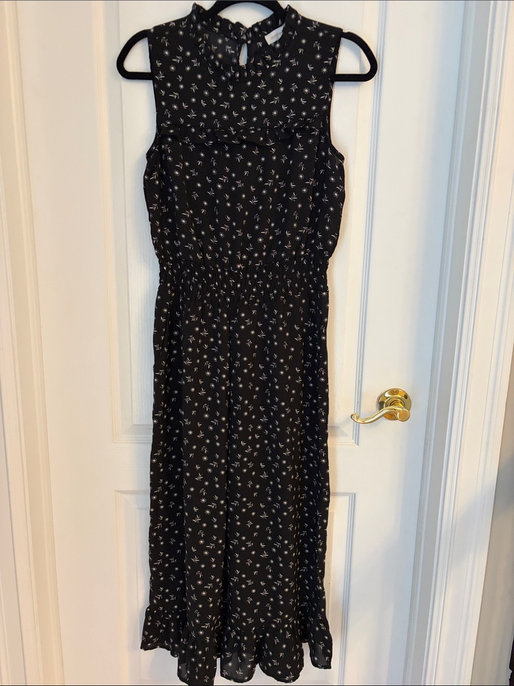 Sleeveless Black Culotte Jumpsuit with White Floral Print and Smocked Waist